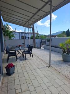 a patio with a table and chairs under a canopy at KATHRIN APPARTS in Alepou