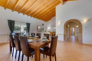 a dining room with a wooden table and chairs at Vila Fantastica in Aljezur +39 photos