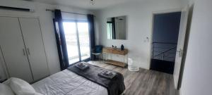 a bedroom with a bed and a large window at KasaNova in Rabo de Peixe