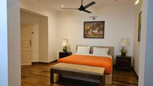 a bedroom with a bed and a ceiling fan at Nora Lyn - Colombo in Colombo