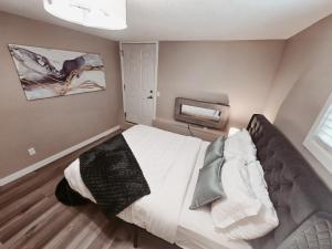 a bedroom with a large bed in a room at Riverfront Condo - Free Parking, Walk DT, Sleep 4 in Calgary