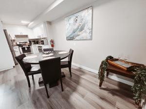 a dining room with a table and a kitchen at Riverfront Condo - Free Parking, Walk DT, Sleep 4 in Calgary