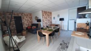 a kitchen and living room with a table and chairs at Gite Spa Zen 2 in Blois +9 photos