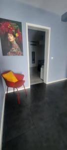 a room with a chair and a painting on the wall at KasaNova in Rabo de Peixe