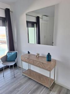 a dressing table with a mirror and a chair at KasaNova in Rabo de Peixe +34 photos