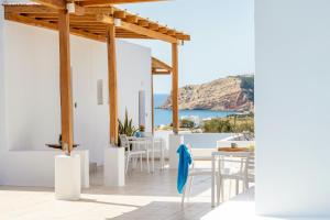 a white house with a view of the ocean at Sarantis Suites & Apartments in Provatas