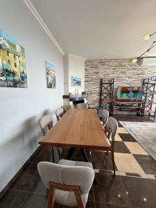 a dining room with a wooden table and chairs at Dhermi Villa 1 in Kondaq