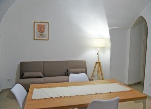 a living room with a couch and a table at DOMUS Canonico in Noto