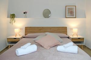 a bedroom with a large bed with two pillows at DOMUS Canonico in Noto
