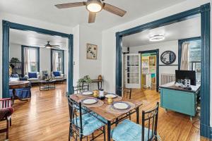 a kitchen and living room with a table and chairs at Lil' Red House On Porter in Detroit