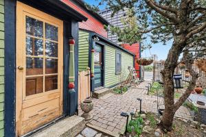 a house with a wooden door on a street at Lil' Red House On Porter in Detroit