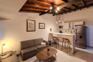 a living room with a couch and a kitchen at Viktory Boutique Hotel in Medellín
