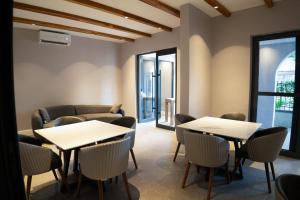 a room with tables and chairs and a couch at Silverado Boutique Hotel in Tanga