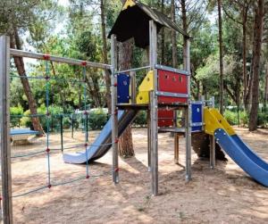 a playground with a slide in a park at Cottage PARKS DI LICCIA in Bonifacio