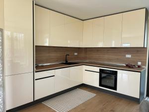 a kitchen with white cabinets and a sink at Villa Belvedere in Varna City +18 photos