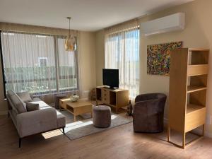 a living room with a couch and a television at Villa Belvedere in Varna City