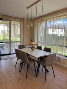 a dining room table with chairs and a vase of flowers at Villa Belvedere in Varna City