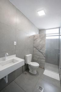 a bathroom with a toilet and a sink and a shower at Vértice Hotel in Brasília