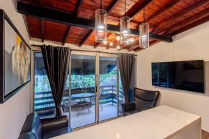 a dining room with a table and chairs and a window at Viktory Boutique Hotel in Medellín
