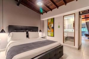 a bedroom with a large bed and a bathroom at Viktory Boutique Hotel in Medellín +60 photos