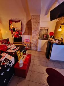 a living room with a bed and a kitchen at Tama67 suite in Ostuni +3 photos