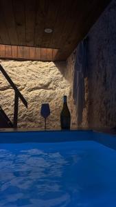 a bottle of wine sitting next to a swimming pool at Tama67 suite in Ostuni