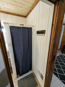 a garage door with a blue curtain in a room at Cozy Studio Cabin #5 Riverside Point Resort in Park Rapids