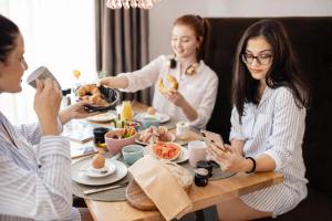 a group of women sitting at a table eating food at Aparthotel Viktorias Home in Kufstein +37 photos