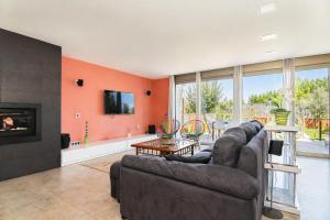 a living room with a couch and a fireplace at 206 Villa Isabel ET2341 by Mallorca Charme in Alcudia