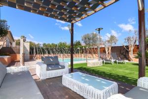 a patio with a table and chairs and a pool at 206 Villa Isabel ET2341 by Mallorca Charme in Alcudia
