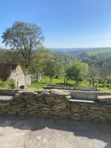 a stone retaining wall in front of a field at THE Old DAIRY in Whitland