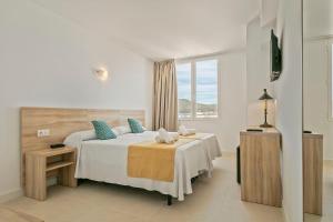 a hotel room with a bed and a window at Suncoast Ibiza Hotel - Adults Only - in Ibiza Town +60 photos