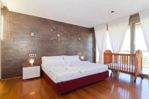 a bedroom with a large bed with a wooden wall at 206 Villa Isabel ET2341 by Mallorca Charme in Alcudia +26 photos
