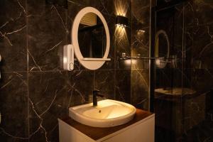 a bathroom with a sink and a mirror at Safir Hotels Silivri in Silivri +56 photos