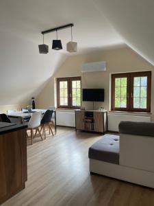 a living room with a couch and a table at Apartamenty Buczyna w Sierakowie in Sieraków