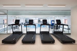 a row of treadmills in a room with a mirror at Delta Hotels by Marriott Halifax Downtown in Halifax