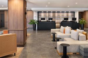 a lobby with couches and chairs and a reception desk at Delta Hotels by Marriott Halifax Downtown in Halifax +72 photos