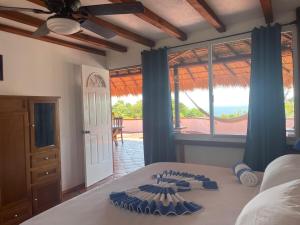 a bedroom with a bed with a view of the ocean at Penthouse Bella Vista in Puerto Escondido +14 photos