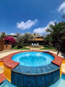 a large pool with a wooden deck around it at Penthouse Bella Vista in Puerto Escondido