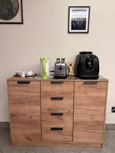 a wooden dresser with a toaster on top of it at La casa nel parco in Chieri