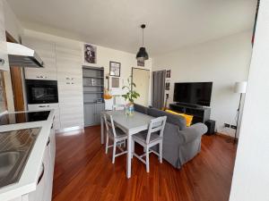 a kitchen and living room with a table and a couch at La Casa sul Serio in Seriate
