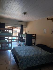 a bedroom with a bed and several bunk beds at adriana hostel in Itacaré +19 photos