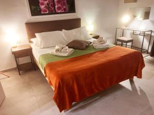 a bedroom with a bed with two towels on it at Basso 61 Urban Oasis with Private Mini Pool & Courtyard - Families & Groups in Palermo