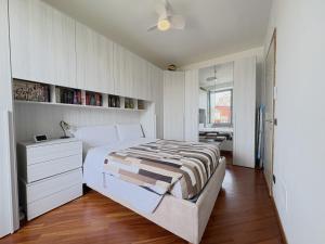a bedroom with a large white bed and a desk at La Casa sul Serio in Seriate +5 photos