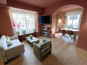 a living room with a couch and a table at Albium Hotel in Albenga