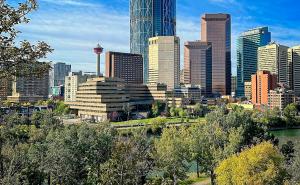 a city skyline with skyscrapers in a city at Riverfront Condo - Free Parking, Walk DT, Sleep 4 in Calgary