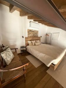 a bedroom with a large bed and a bench at Casa Rama D Oliveira in Barrada