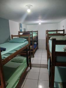 a room with three bunk beds in a room at adriana hostel in Itacaré