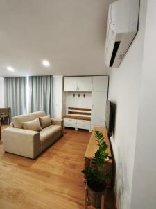 a living room with a couch and a table at Casa d'Avó Guesthouse and Apartment in Urzelina