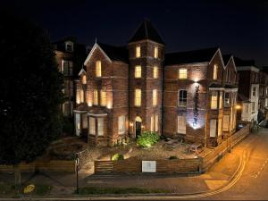 a large brick building with lights on it at night at Craven Suite in Scarborough